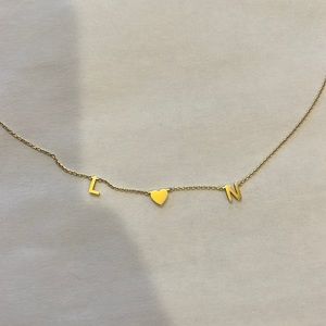 Custom letter necklace. Reads L 💗 N